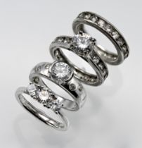 Selection of 4 CZ silver rings 2 of which are a matching set