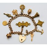A 9ct gold charm bracelet with eleven charms in total (mainly gold), approx. 30.6g.