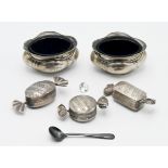 Three modern silver novelty pill boxes in the form of sweets together with a pair of silver salts