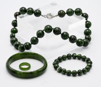 A collection of modern Jade style' jewellery including bangle, bead necklace, bead bracelet and ring