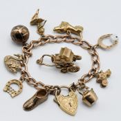 A 9ct gold charm bracelet with ten charms also 9ct gold, total weight approx. 37.5g.