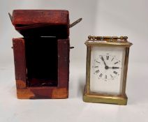 A brass carriage clock with platform escapement and original travel case.