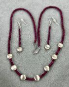 A modern 9ct white gold ruby bead necklace, together with matching earrings.