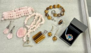 A collection of modern dress jewellery including rose quartz, pendants, bracelet, earrings, ring.