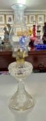 A clear glass oil lamp, height 40cm.