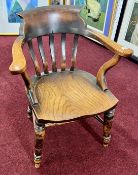 An antique Captain's chair, with elm seat, turned legs and 'H' stretchers.