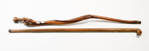Two walking canes to include a carved dogs head, signed Kepknpa (2).