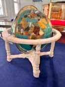 A semi-precious gemstone globe, each type of stone is placed geographically on the globe according