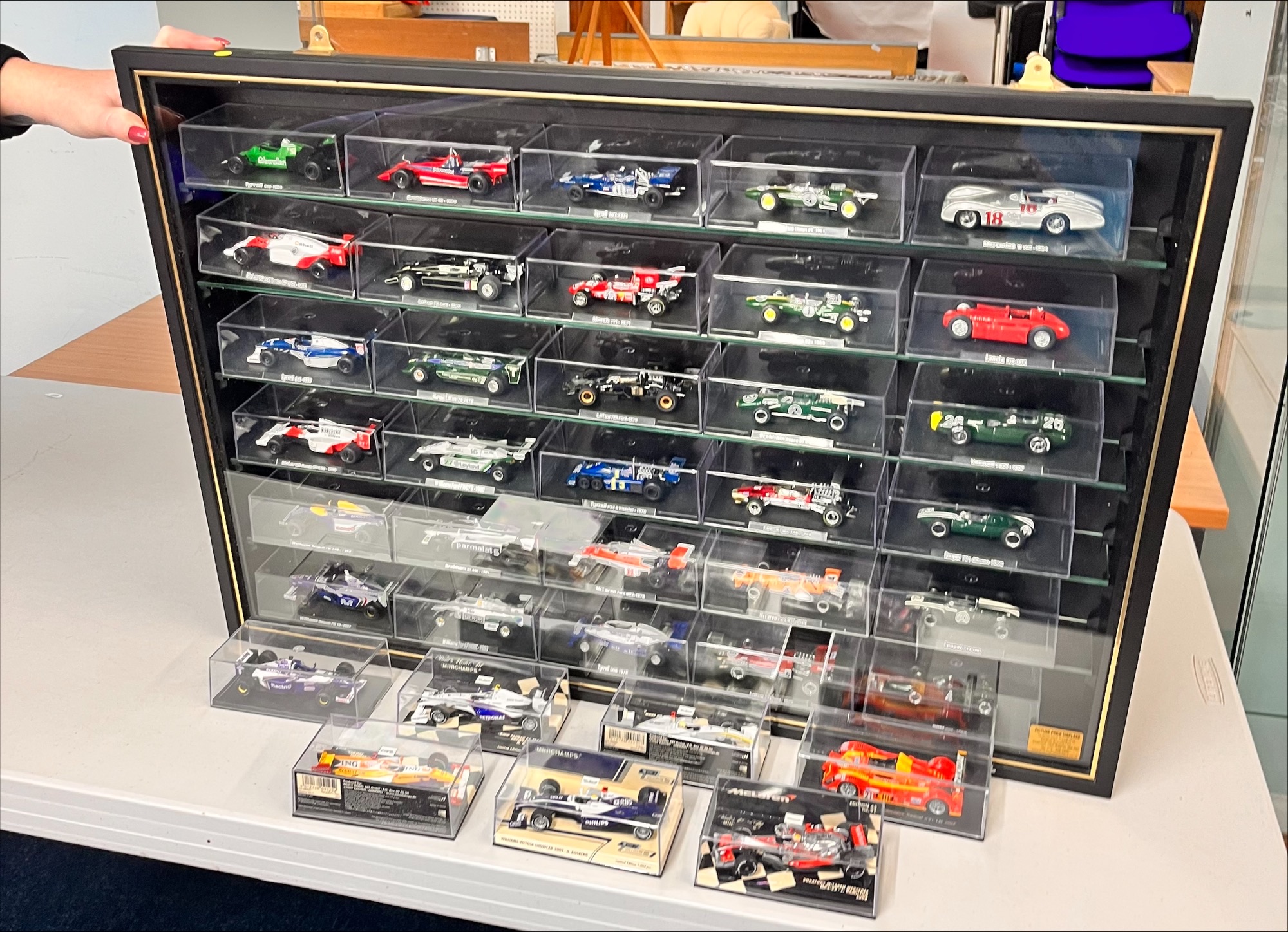 A set of model cars, to include thirty-seven cars encased in individual ...