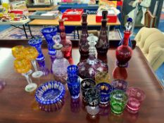 A collection of Bohemian coloured glass to include seven decanters etc.