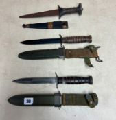 Three military knives, cased, including one marked to the case U.S. M8 B.M.Co the knife marked U.