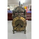 A 20th century Smith's brass lantern clock, with pierced dolphins decoration, number EW264/53,