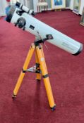 A boxed Telescope on wooden stand, with achromatic coated lens.