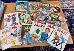 A collection of magazines including Howard Duck, a DC special magazine, Mad magazines and Bubble-gum