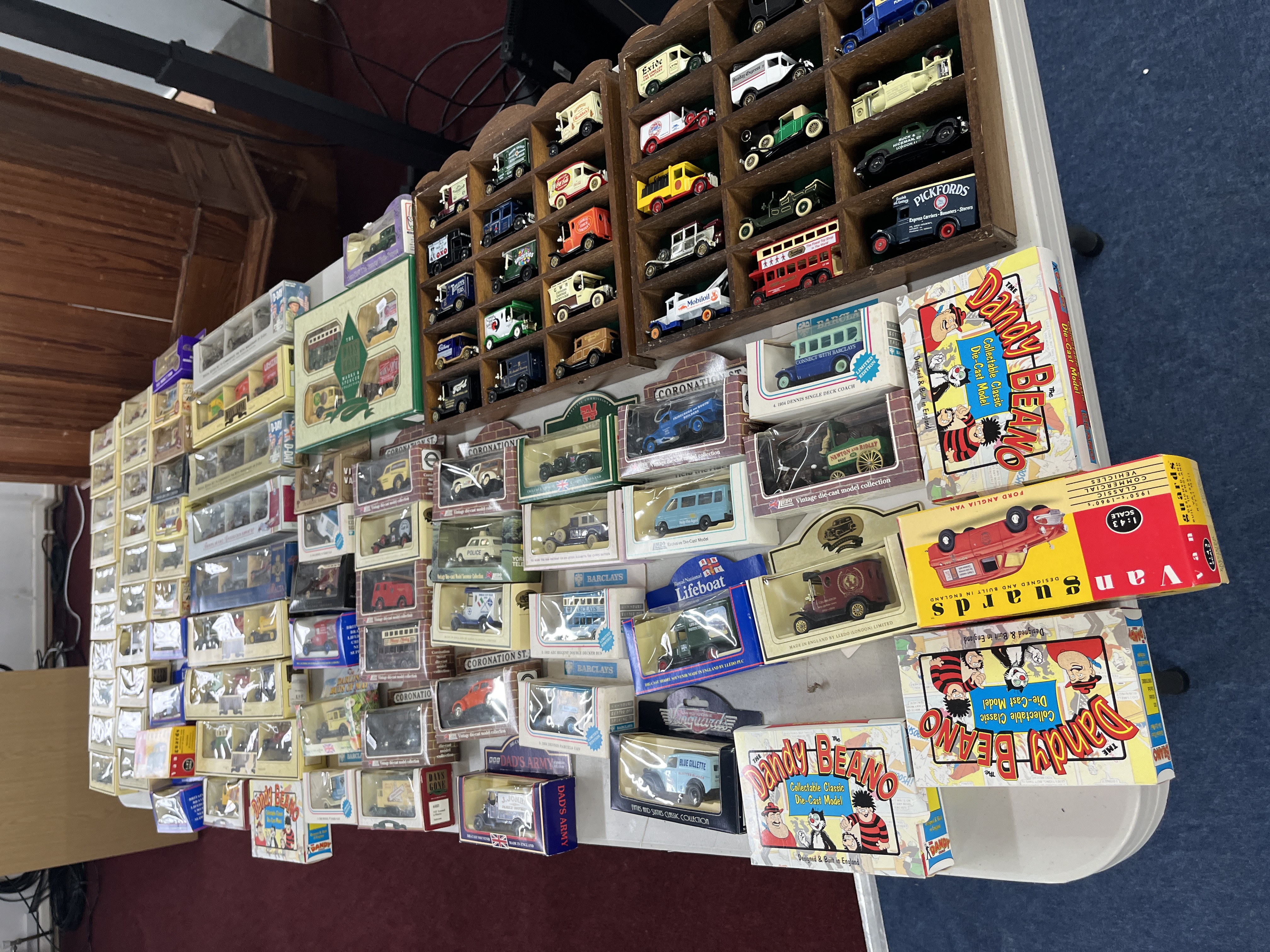 A large collection of model diecast cars. Mostly commercial vehicles, with a number of military
