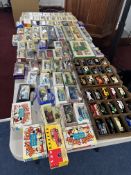 A large collection of model diecast cars. Mostly commercial vehicles, with a number of military