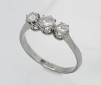 A platinum three stone graduated diamond ring, Size Q