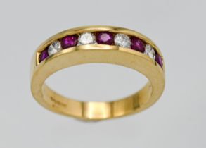 An 18ct ruby and diamond half band eternity ring set with nine stones. Size M.