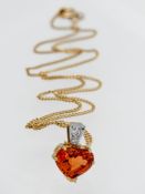 An 18ct gold single stone heart shape Mandarin Garnet approx. weight 6.18ct set with two small round