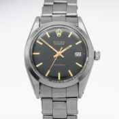Rolex, an Oysterdate Precision stainless steel wristwatch with black baton dial, running. Case