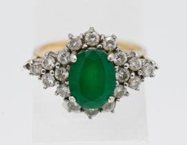 An 18ct yellow gold diamond and emerald cluster ring, size N.