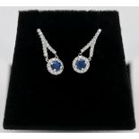 A pair of 18ct diamond and sapphire drop earrings.