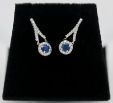 A pair of 18ct diamond and sapphire drop earrings.