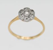 An 18ct yellow gold and platinum diamond set cluster ring, size L.