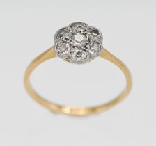 An 18ct yellow gold and platinum diamond set cluster ring, size L.