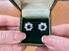 A pair of white gold CZ cluster studs.