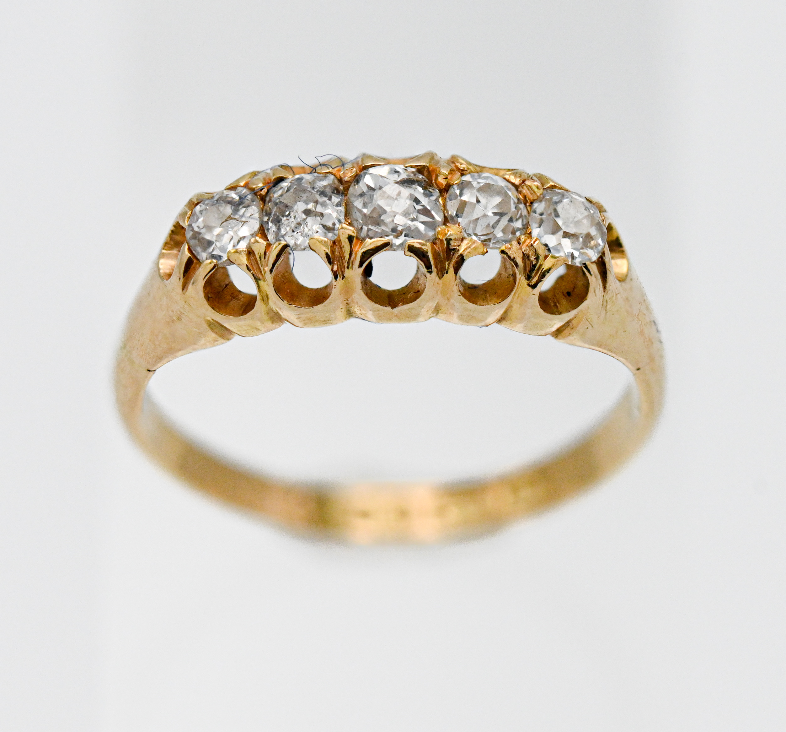 An 18ct yellow gold five stone diamond ring, (old cut diamonds), size K.