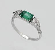An 18ct white gold emerald and diamond ring. Size P.