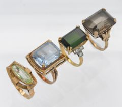 A group of four vintage large stone set rings comprising two 9ct rings (14.70g), an 18ct ring (7.5g)