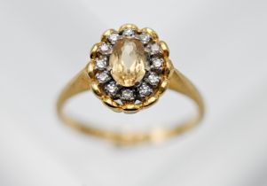 An 18ct yellow gold diamond and topaz cluster ring, total weight of diamond approx. 0.12ct, colour