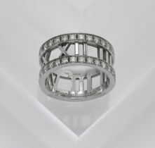 A Tiffany 'Roman Numerals' diamond band with pouch and box, size K.