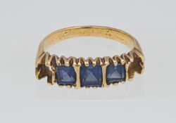 A sapphire ring set in yellow gold (unmarked), missing two stones.