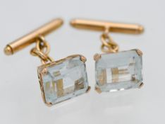 A pair of aquamarine and gold cufflinks.