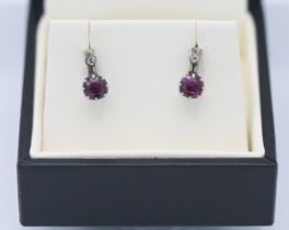 A pair of 9ct white gold ruby and diamond drop earrings.