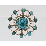 A Victorian yellow gold open filigree work round turquoise set brooch, approx. 3.5g.