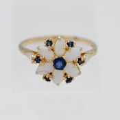 An opal and sapphire cluster ring. Size U.
