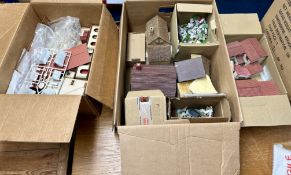 A large collection of buildings, terrain kits and models, to include small standing characters (