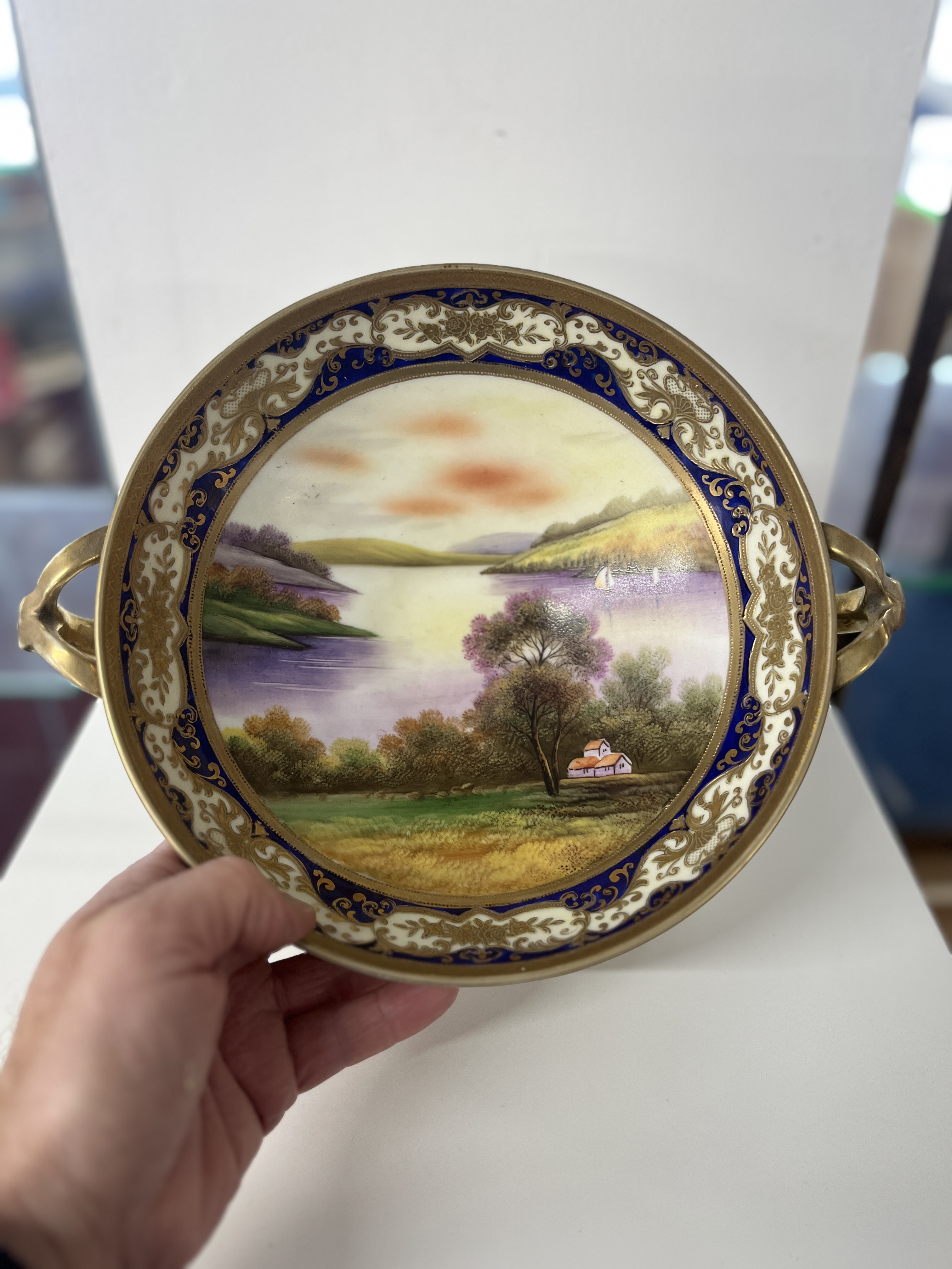 Noritake, Japanese porcelain comport on stand the bowl decorated with a landscape river