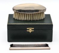 As new green cased grooming set comprising oval silver topped brush and silver spined comb combo -