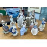 A collection of Lladro & Nao figurines, three Lladro and six Nao.