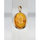 A Honey coloured Baltic amber gold (hallmark 585) pendant with some fossils naturally trapped in the