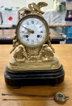 A 19th century French gilt clock decorated with birds on a plinth base, with eight day bell striking