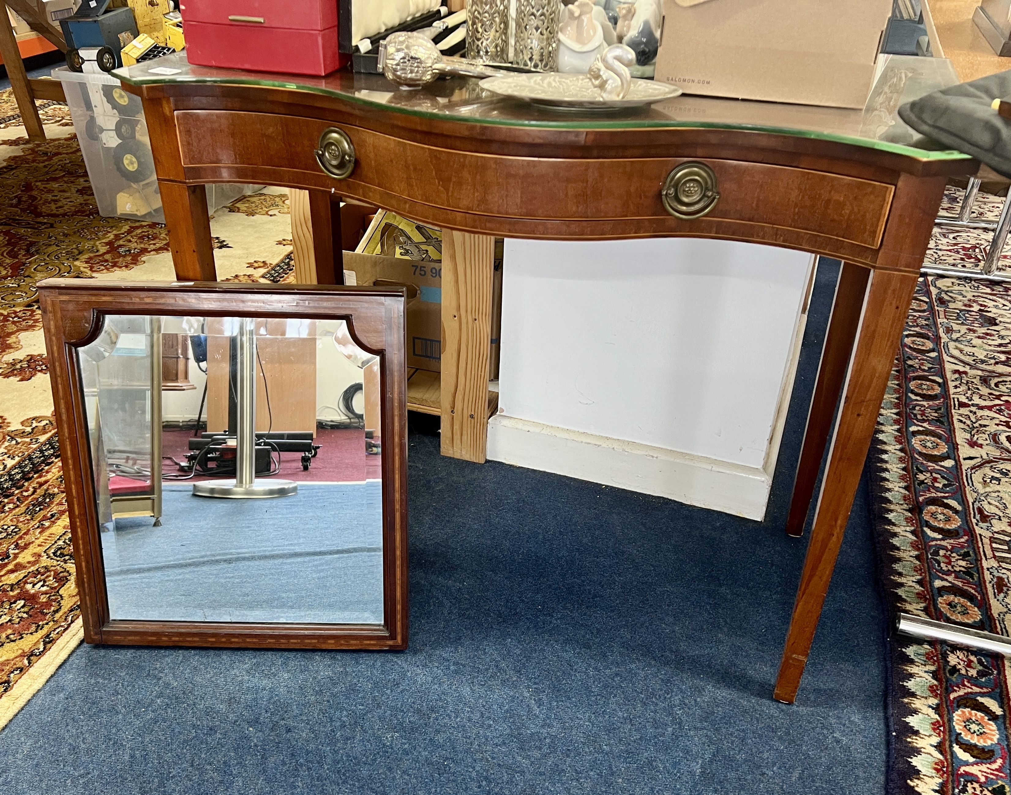 Antique mahogany side table fitted with a drawer, serpentine and a mahogany framed wall mirror