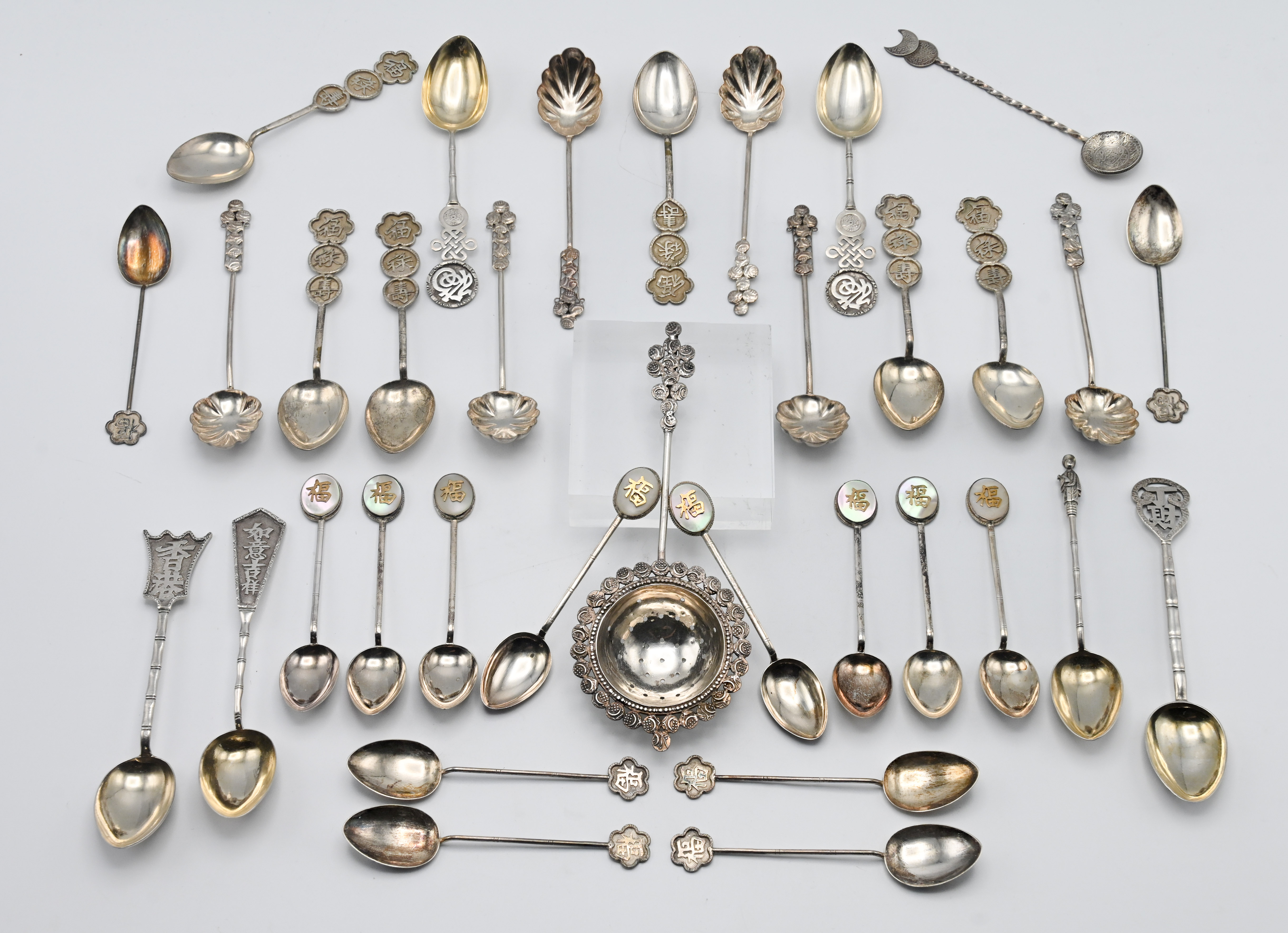 A collection of Hong Kong sterling and other silver and white metal fancy teaspoons, also a tea