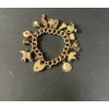 A 9ct gold charm bracelet, approx. 61.73g