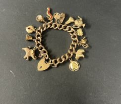 A 9ct gold charm bracelet, approx. 61.73g